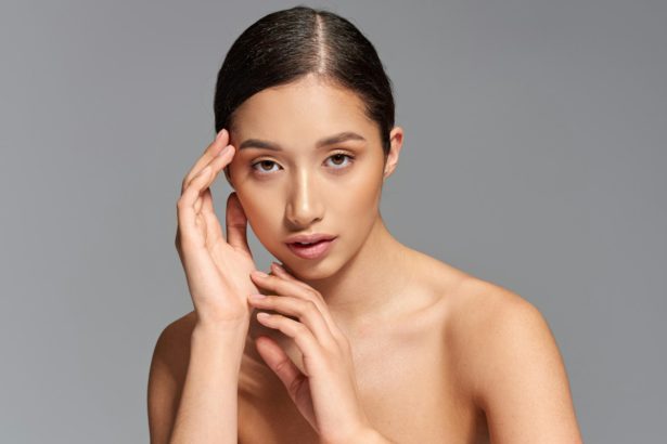 beauty industry, skin care, young asian woman with brunette hair posing near beauty products