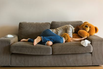 Depressed young woman crying on the couch, stress, anxiety, loneliness